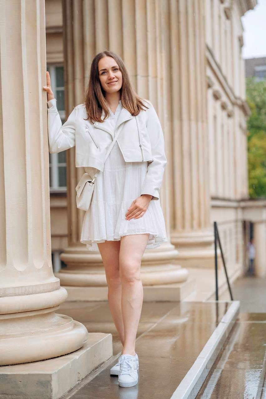 Yuliya standing among the columns of an old building